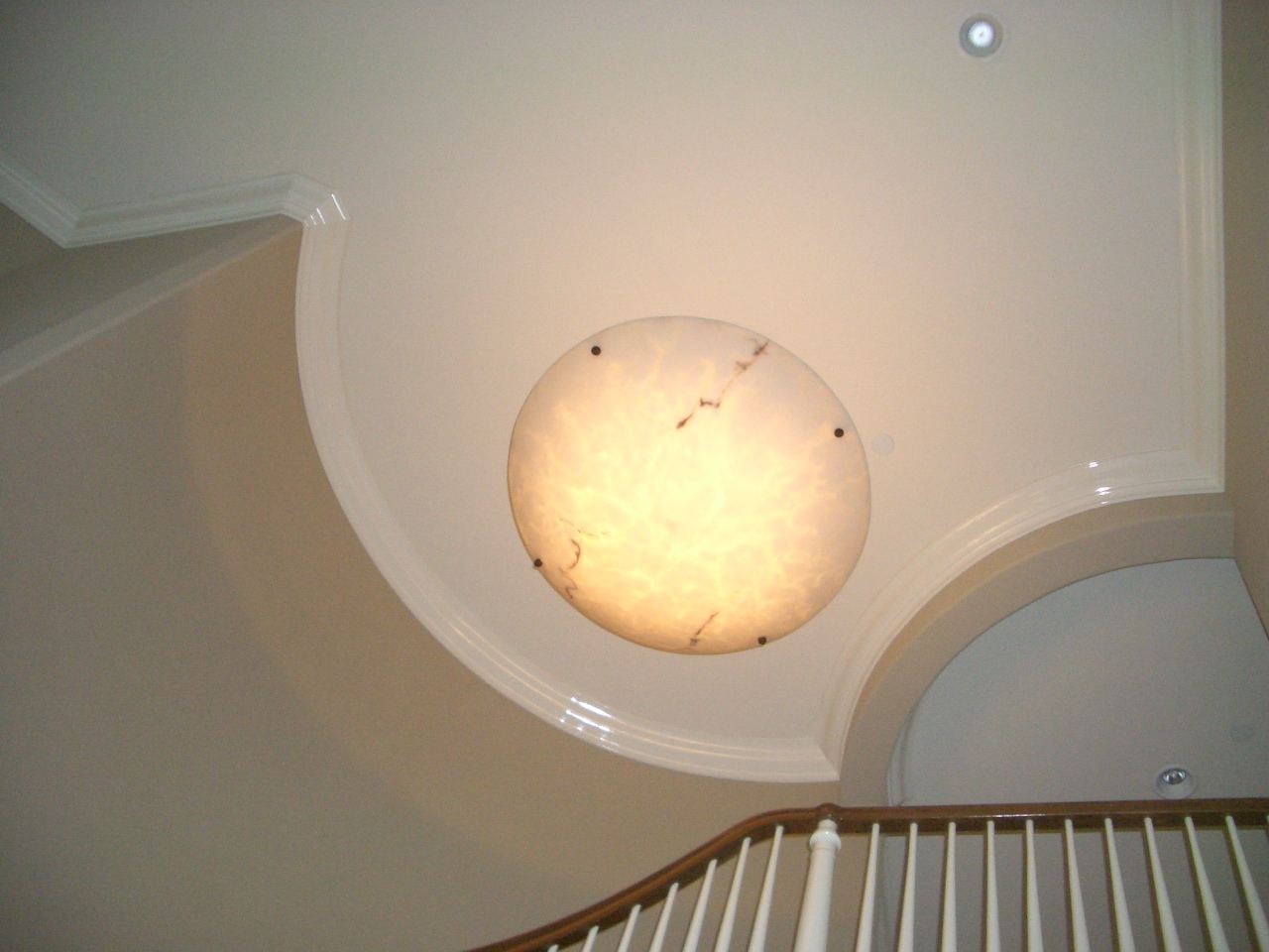 Oval crown molding over a staircase